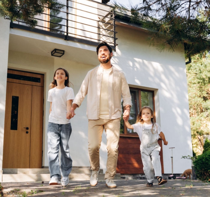 Family enjoying time together outside their home on a sunny day