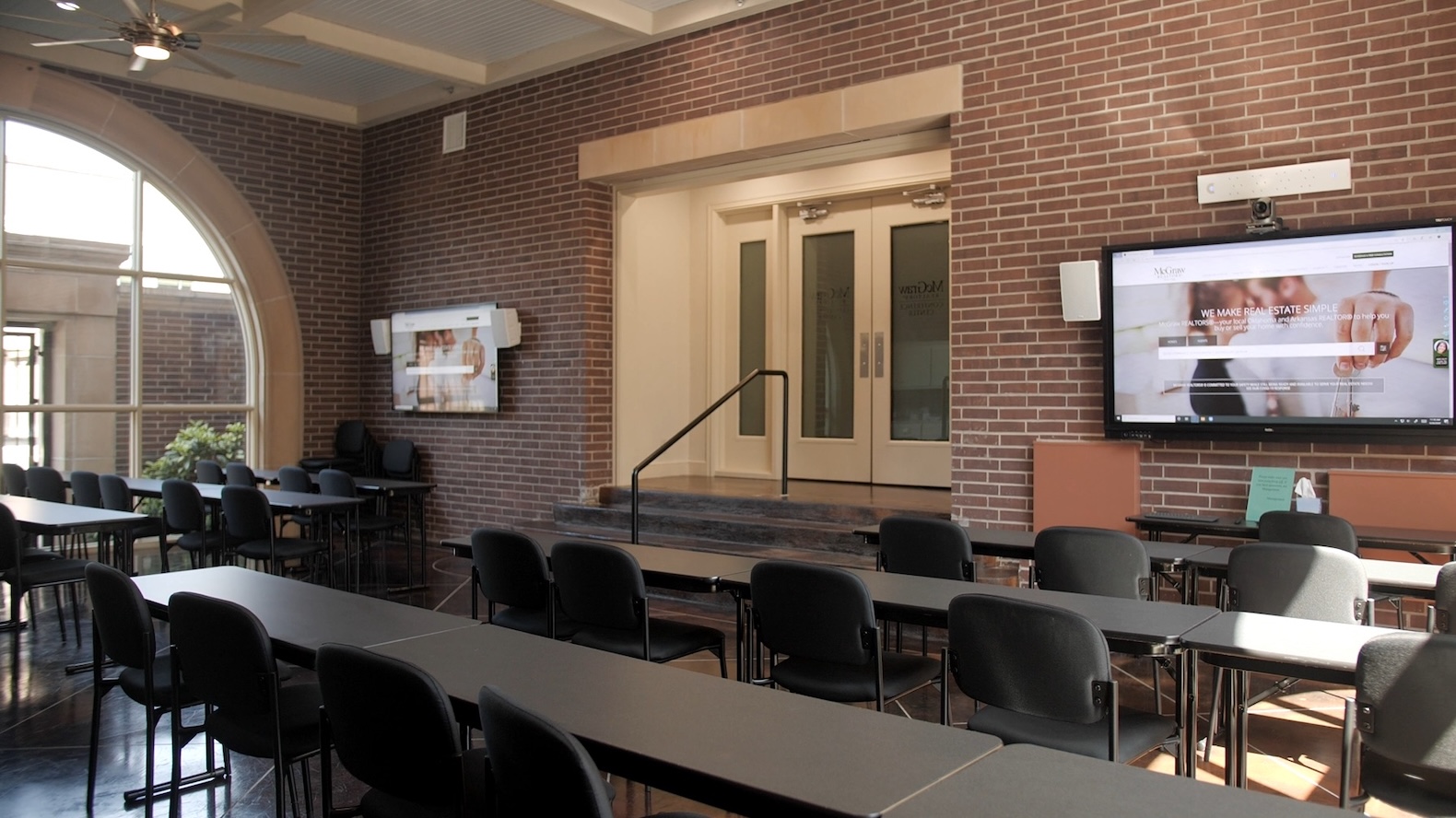 Modern conference room with large windows and presentation screens