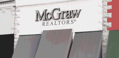 McGraw Realtors building exterior with awnings and signage in an urban setting
